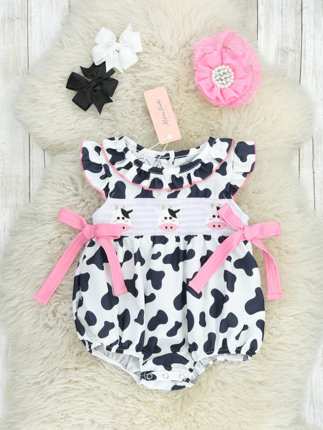 Smocked Cow Print Bow Ruffle Romper