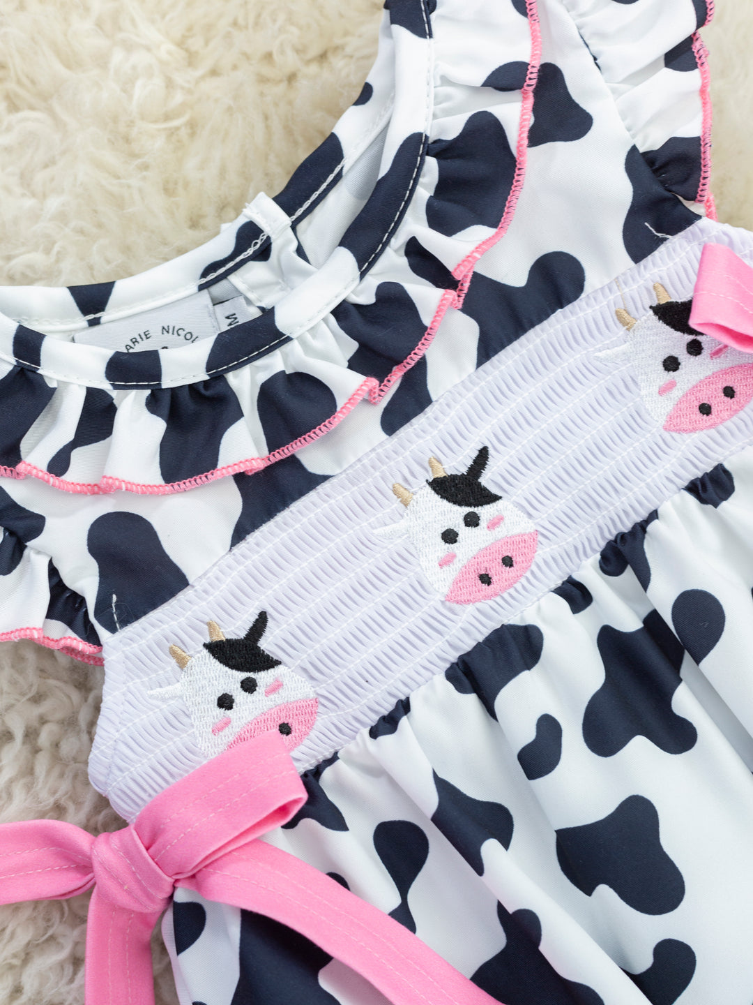 Smocked Cow Print Bow Ruffle Romper